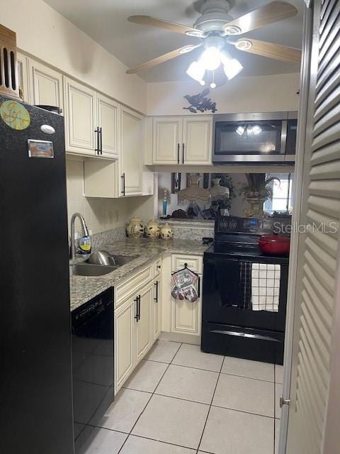 kitchen with black appliances, sink, ceiling fan, light tile patterned flooring, and light stone counters