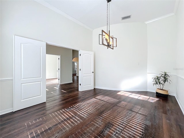 unfurnished dining area with ornamental molding, dark hardwood / wood-style flooring, lofted ceiling, and a notable chandelier