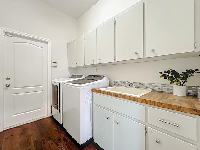 laundry room with separate washer and dryer, sink, cabinets, and dark hardwood / wood-style floors