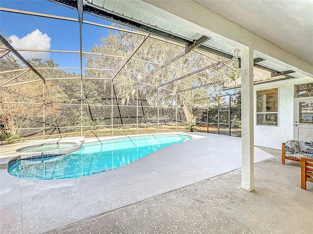 view of pool featuring glass enclosure, an in ground hot tub, and a patio