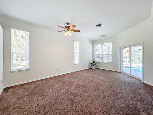 spare room featuring ceiling fan, carpet floors, and ornamental molding