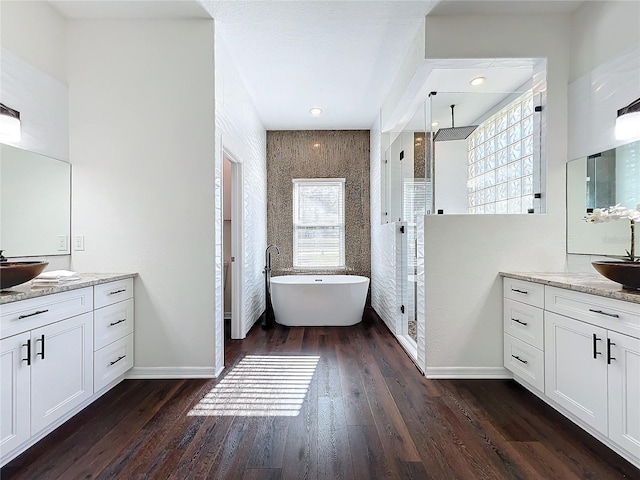 bathroom featuring separate shower and tub, vanity, and hardwood / wood-style flooring