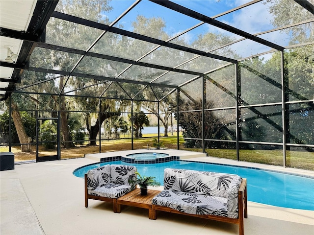 view of pool featuring a lanai, a patio area, and an in ground hot tub