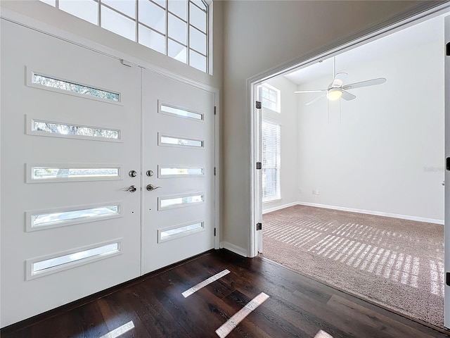 entryway featuring french doors, a towering ceiling, dark hardwood / wood-style floors, and a healthy amount of sunlight