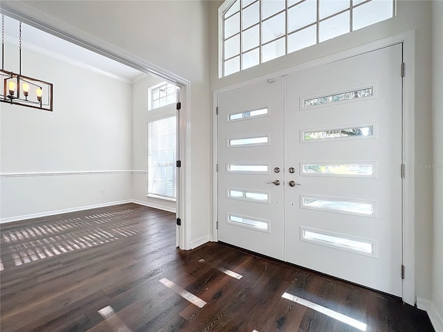 entrance foyer with crown molding, dark hardwood / wood-style flooring, and french doors