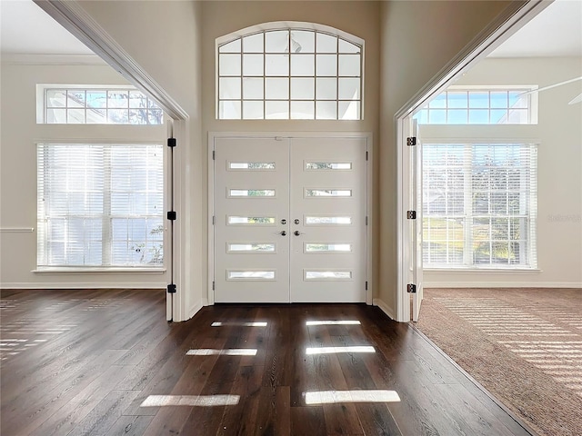 foyer featuring french doors, a high ceiling, and dark hardwood / wood-style floors