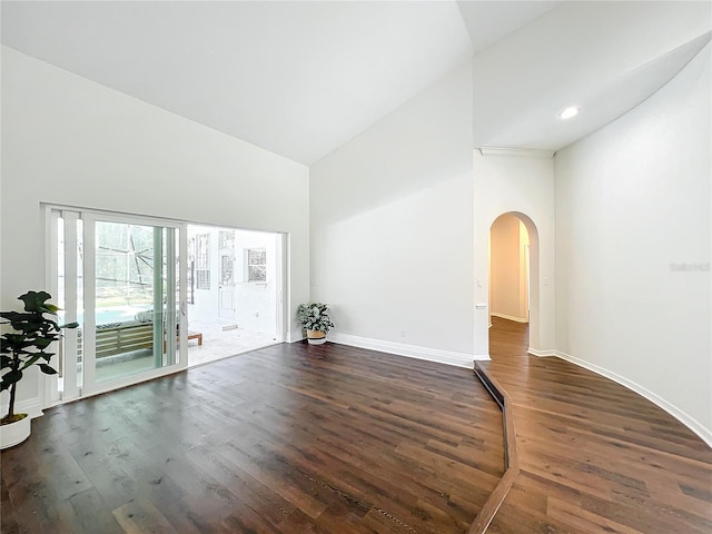 interior space featuring high vaulted ceiling and dark hardwood / wood-style floors