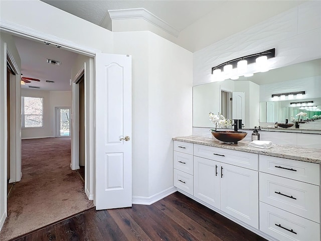 bathroom with wood-type flooring, vanity, and ceiling fan