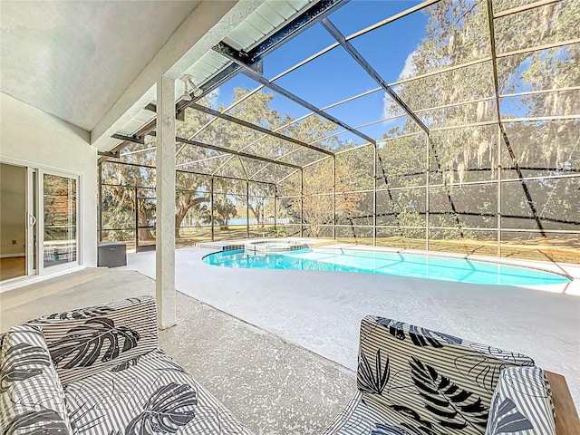 view of pool featuring glass enclosure and a patio