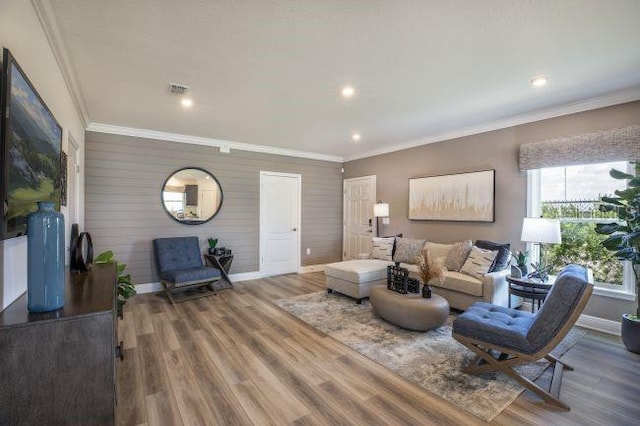 living room with hardwood / wood-style floors and crown molding