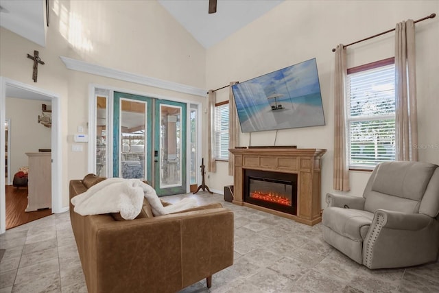 living room with french doors, light hardwood / wood-style floors, and high vaulted ceiling