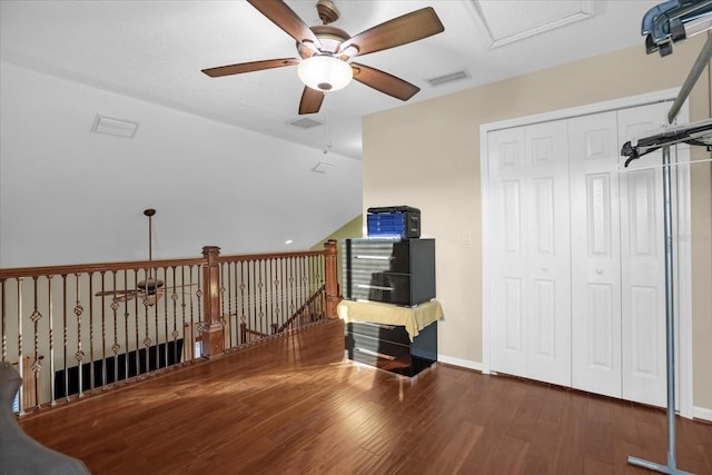 additional living space featuring ceiling fan and dark wood-type flooring