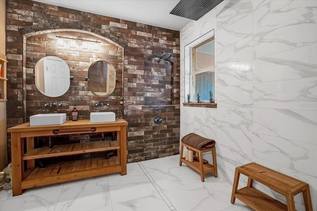 interior space featuring vanity, walk in shower, and brick wall