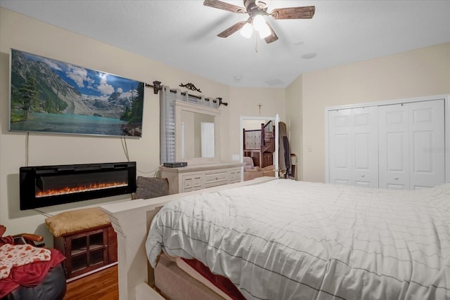 bedroom featuring ceiling fan, a closet, and wood-type flooring