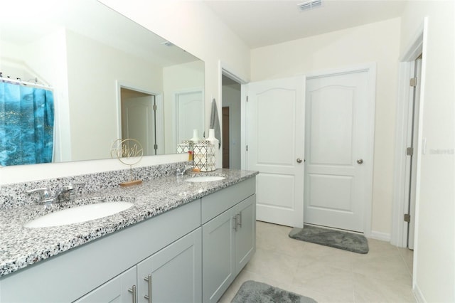 bathroom with tile patterned flooring and vanity