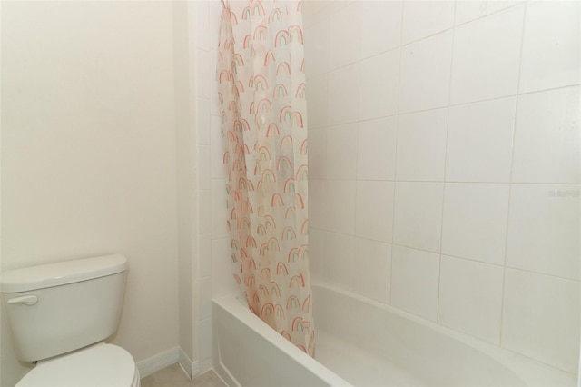 bathroom with toilet and shower / bath combo with shower curtain