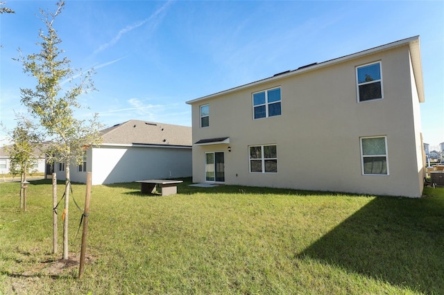 rear view of house with a yard