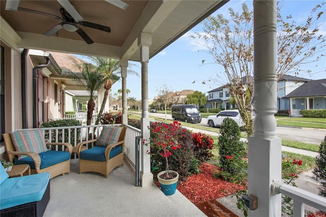 view of patio with ceiling fan and a porch