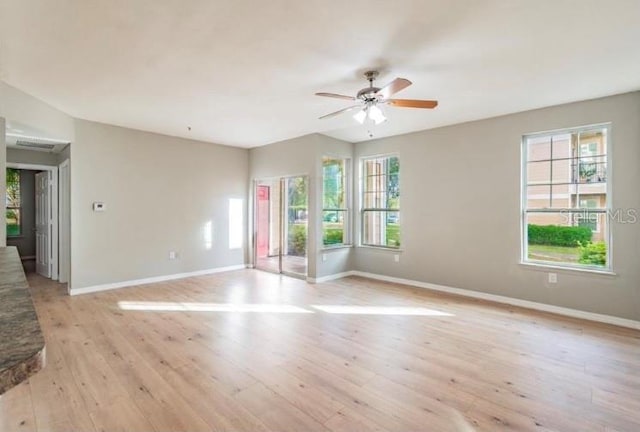 unfurnished room featuring light wood-type flooring and ceiling fan