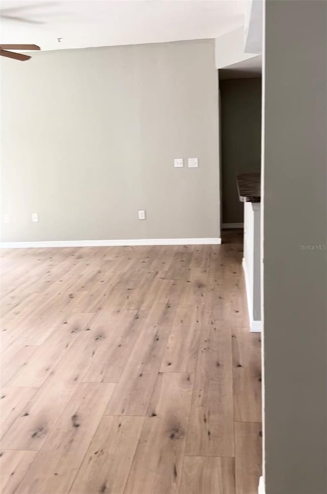 spare room featuring light wood-type flooring and ceiling fan