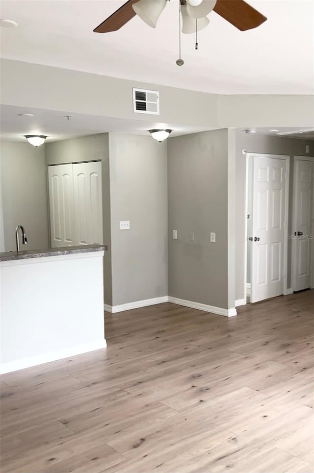 spare room featuring ceiling fan and light hardwood / wood-style flooring