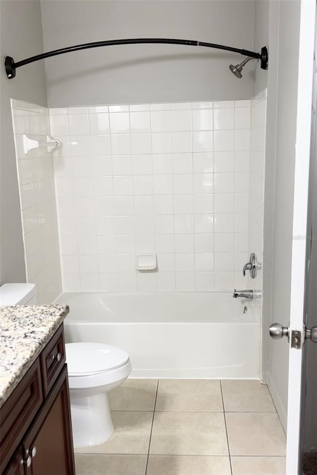 full bathroom featuring tile patterned flooring, vanity, toilet, and tiled shower / bath