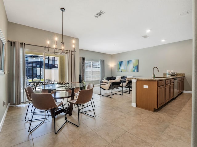 tiled dining area featuring an inviting chandelier and sink