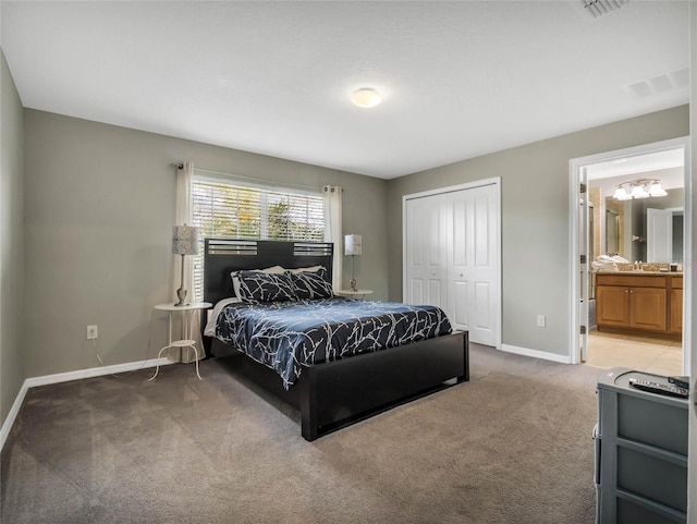 carpeted bedroom with connected bathroom and a closet