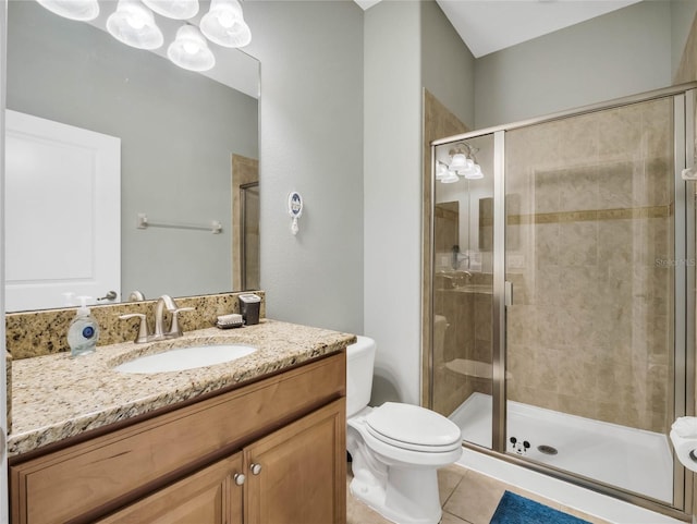 bathroom with tile patterned flooring, vanity, toilet, and a shower with door