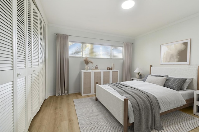 bedroom with crown molding and light hardwood / wood-style flooring