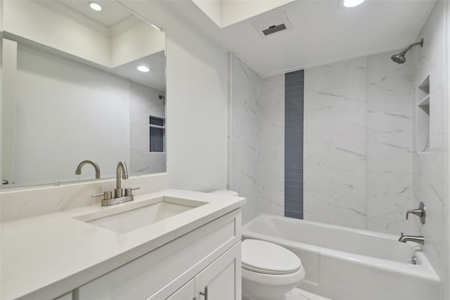 full bathroom featuring tiled shower / bath, vanity, ornamental molding, and toilet