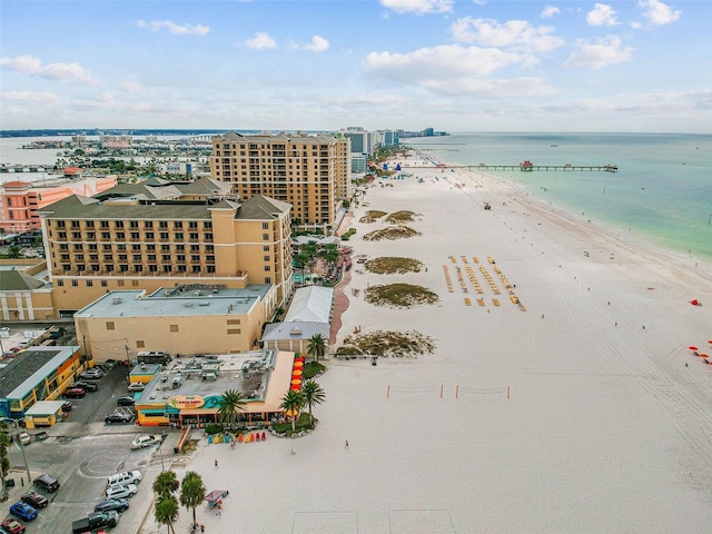 drone / aerial view with a water view and a beach view