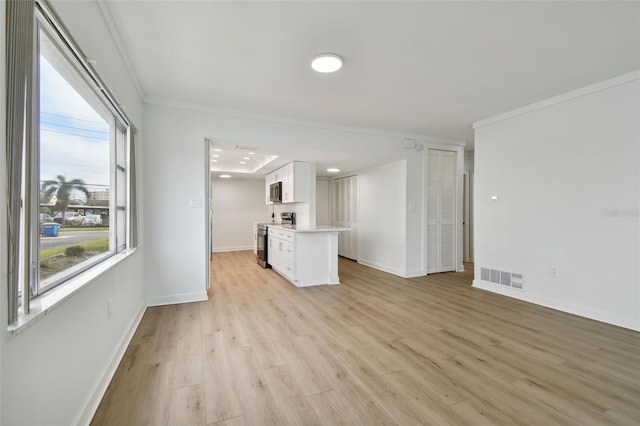 kitchen featuring light wood-type flooring, white cabinetry, crown molding, and appliances with stainless steel finishes