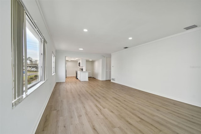 unfurnished living room featuring light hardwood / wood-style floors and ornamental molding