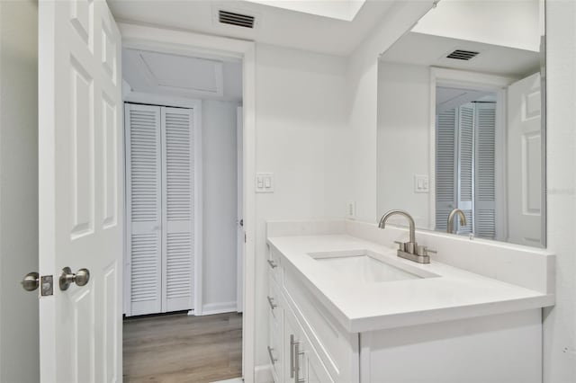 bathroom with hardwood / wood-style flooring and vanity