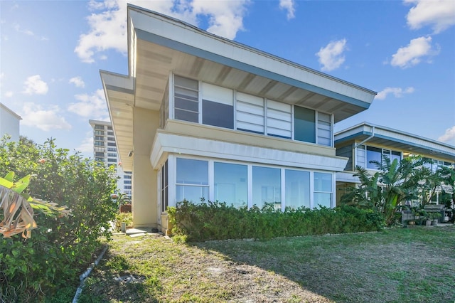 view of side of home with a lawn