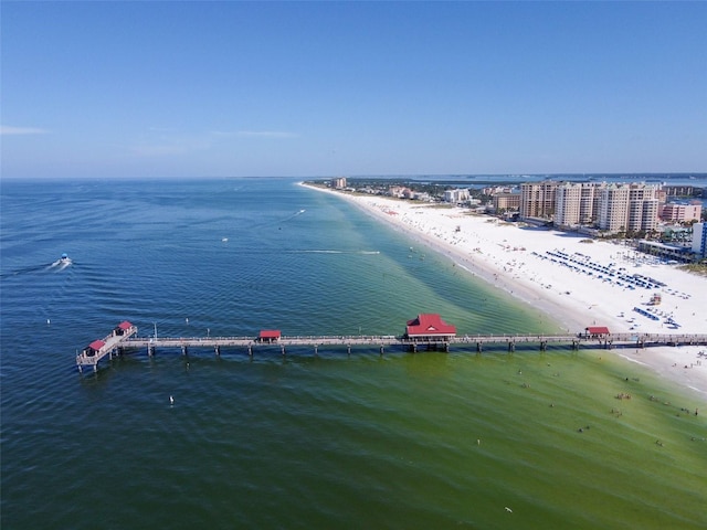 bird's eye view featuring a water view and a beach view