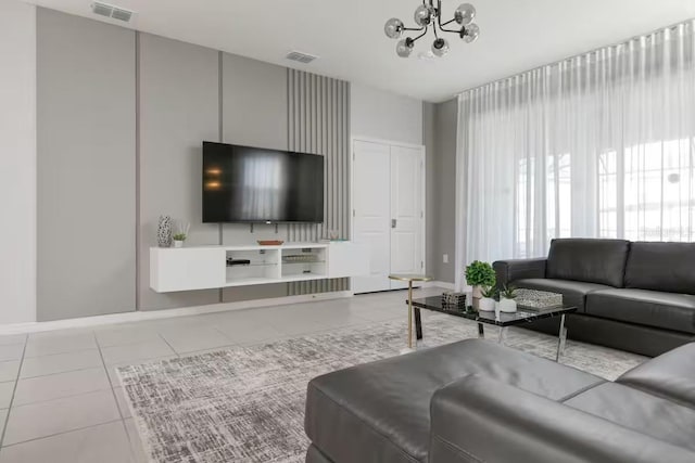 living room featuring light tile patterned flooring and a chandelier