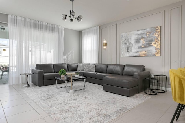 living room with light tile patterned floors and a chandelier