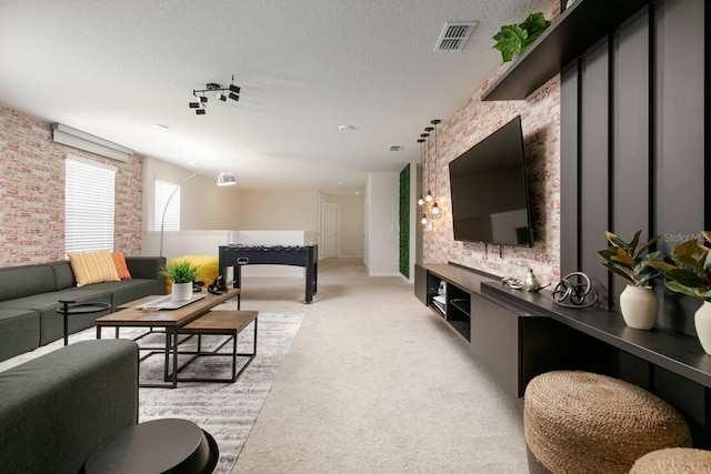 carpeted living room featuring a textured ceiling