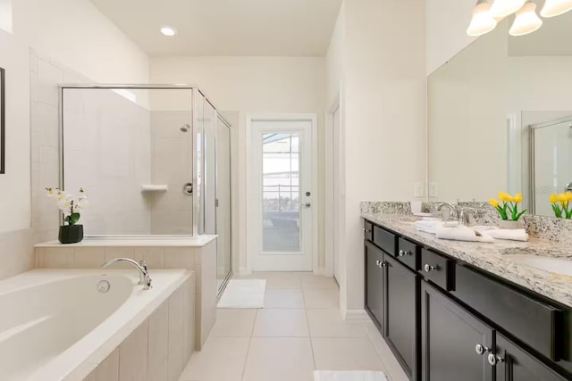 bathroom featuring tile patterned flooring, vanity, and independent shower and bath