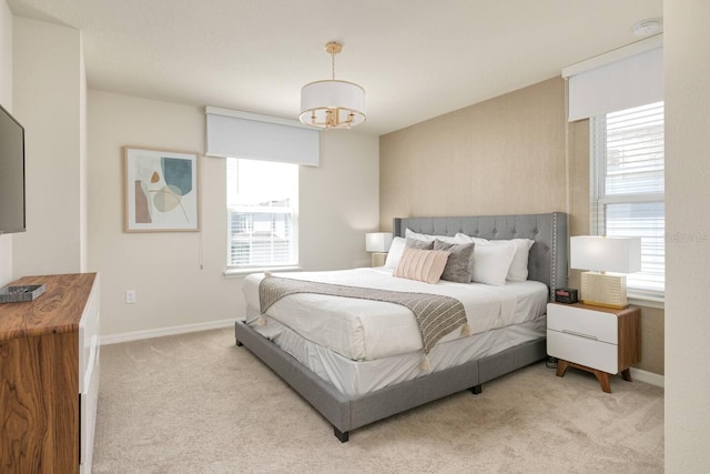 carpeted bedroom featuring a chandelier