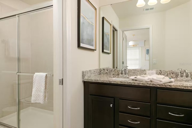 bathroom with vanity and walk in shower