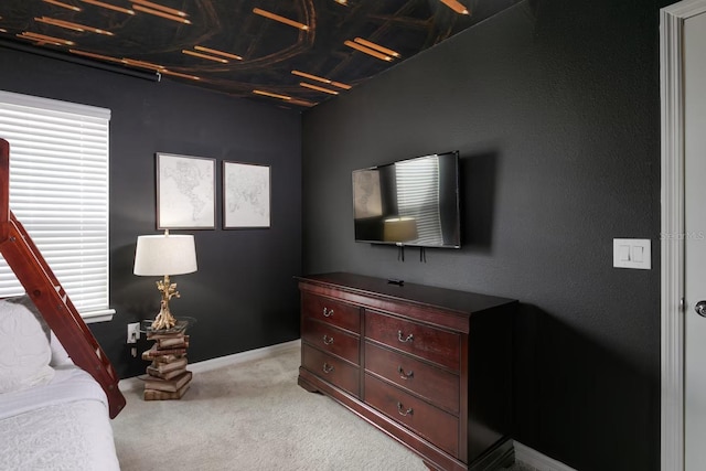 bedroom featuring light colored carpet and coffered ceiling