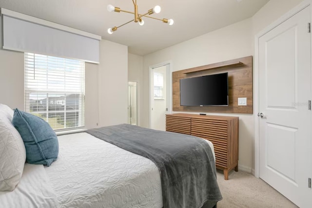 carpeted bedroom with a notable chandelier