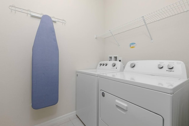 laundry area featuring light tile patterned flooring and independent washer and dryer