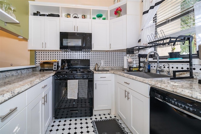 kitchen with white cabinetry, sink, decorative backsplash, and black appliances