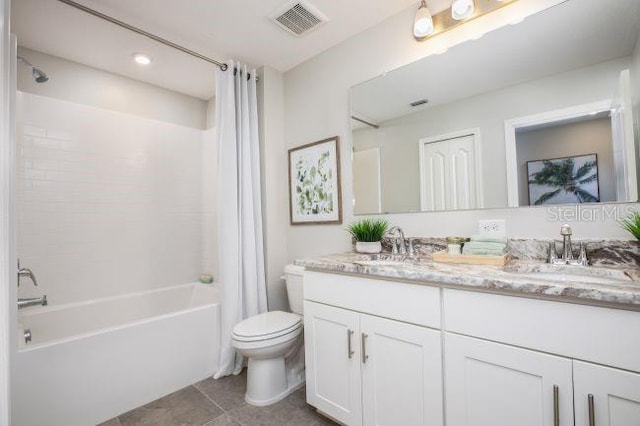 full bathroom featuring tile patterned floors, vanity, toilet, and shower / tub combo