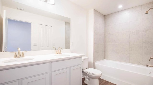 full bathroom with toilet, vanity, tiled shower / bath combo, and hardwood / wood-style flooring