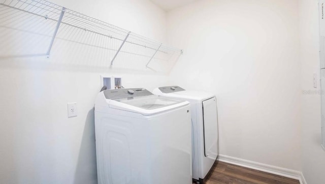 laundry area featuring dark hardwood / wood-style floors and washing machine and dryer